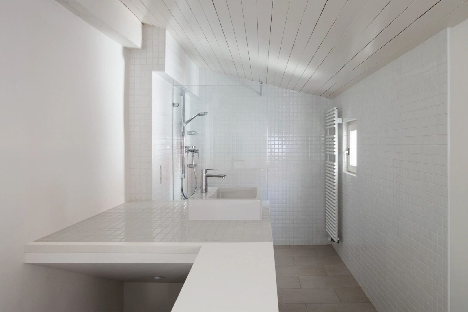 A bathroom with white walls and floors.